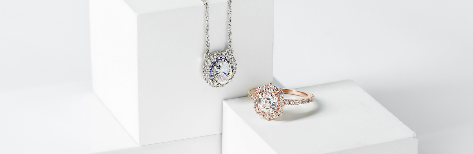 A necklace and engagement ring with vintage design elements