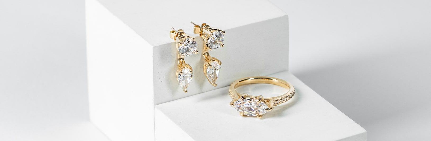 Yellow gold drop earrings and a yellow gold ring with a marquise stone